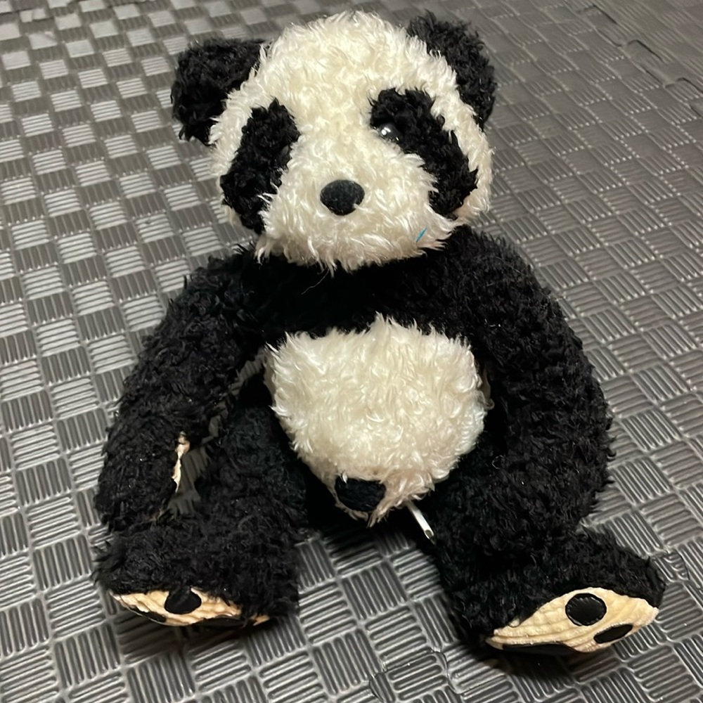 Panda stuffed animal by bamboo